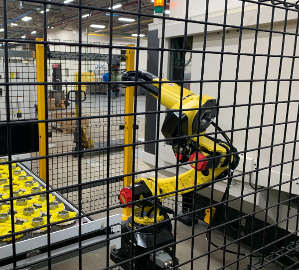 Robot loading and unloading a conveyor